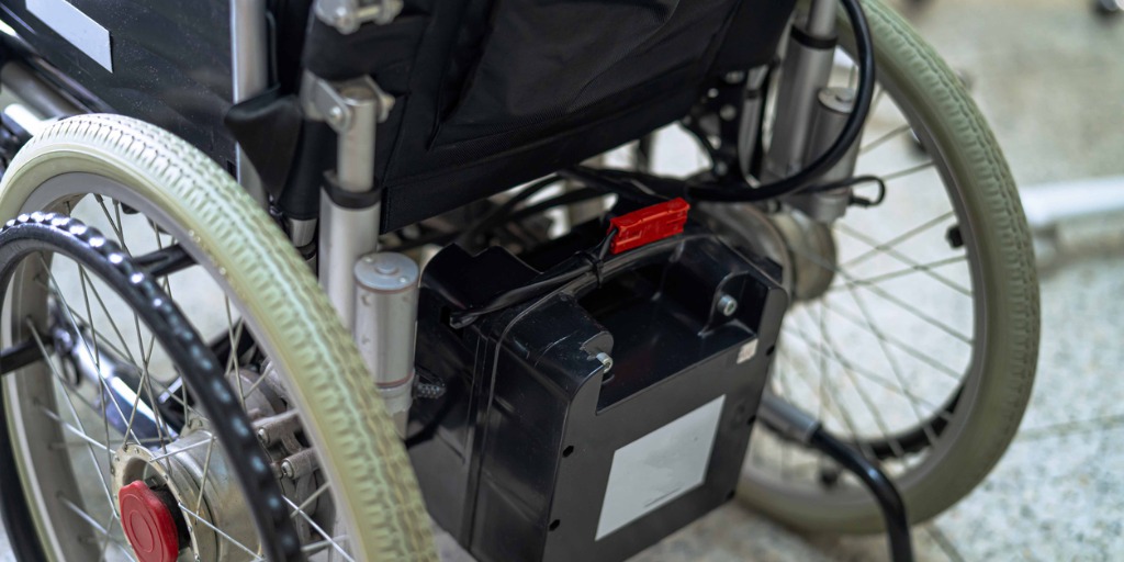 Power assists for manual wheelchairs