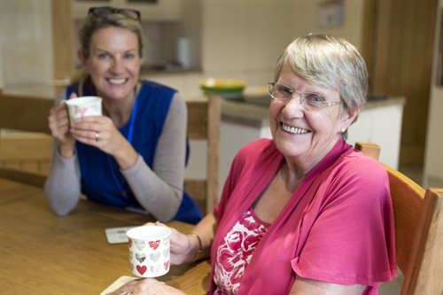 Two ladies chatting over a cup of tea