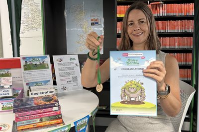 Hayley Coles with Summer Reading Challenge rewards August 2025