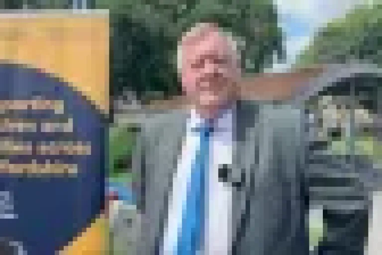 Man stood infront of infographic