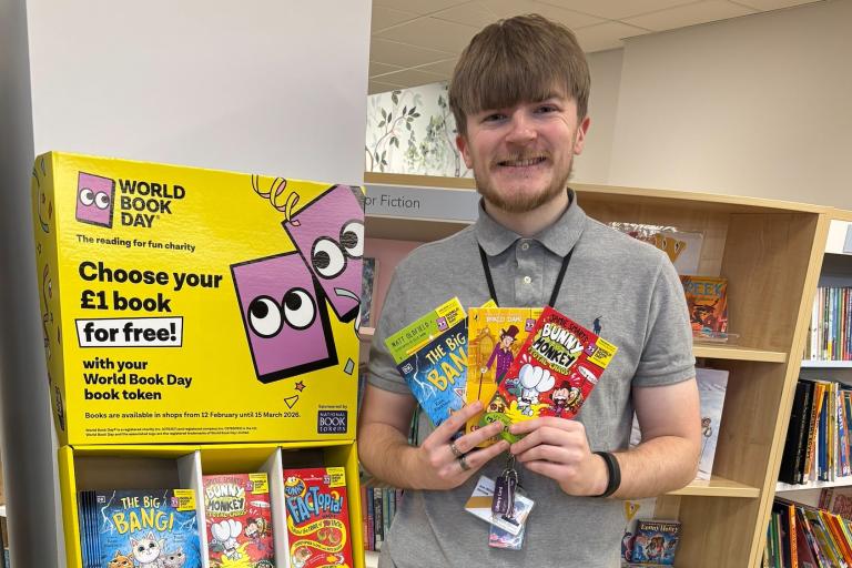 Library assistant at Burton Library with World Book Day display
