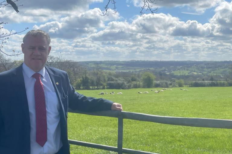 Anthony Screen by a field with livestock