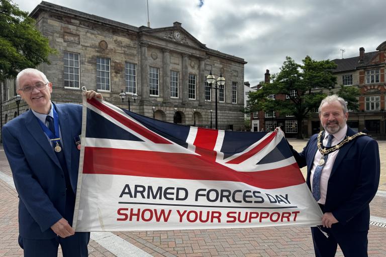 Chairman and Vice Chairman with Armed Forces flag outside Shire Hall