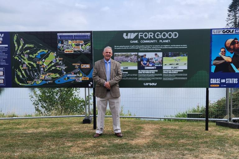Patrick Allen next to signs promoting the LIV Golf championship event at JCB Golf and Country Club