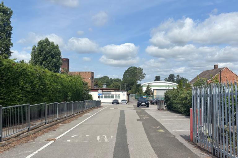 A landscape picture of a school site. The school sites nestled in the distance.