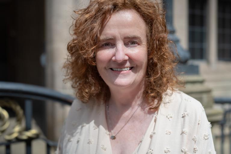 Image shows caucasian women with brown curly hair