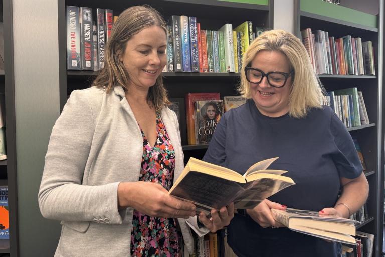 Hayley Coles inside library with Joss Scantlebury looking at books
