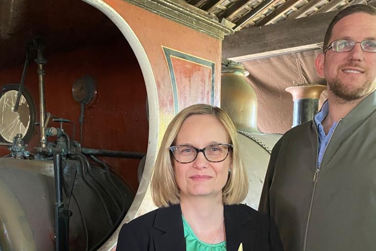Jo Terry and Richard Lewis of the Archives service standing in front of the locomotive
