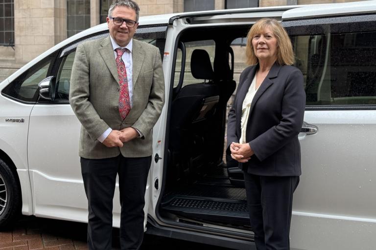 Andrew Mynors and Janet Higgins stood in front of taxi