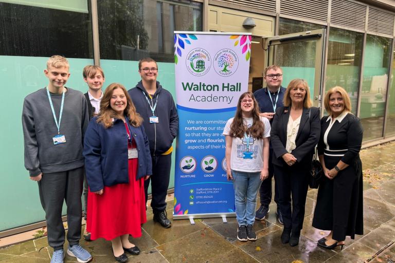 Janet Higgins, Cabinet Member for Education and SEND, and Julie Wood, Academy Principal, pictured with Walton Hall Academy pupils alongside a display banner.