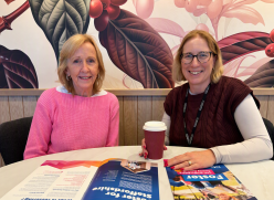 Ann Ager and Emma Howitt at sitting at a desk at a Fostering Information session