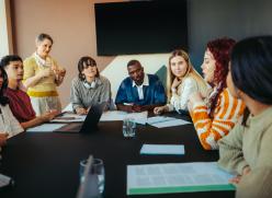 group of professionals round a meeting table