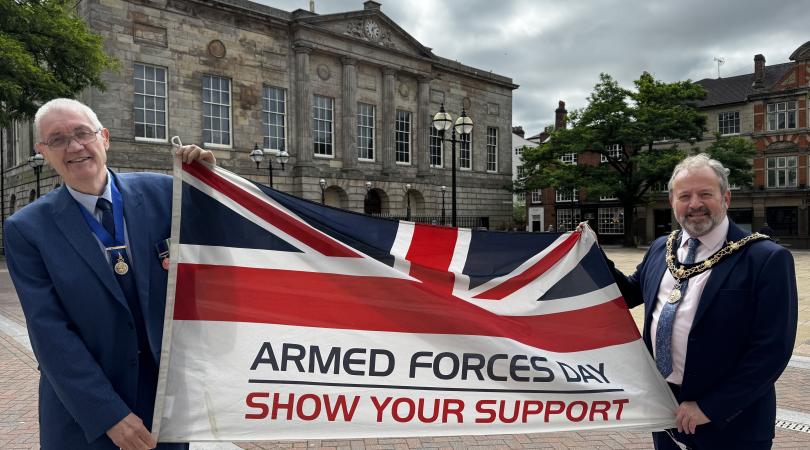 Chairman and Vice Chairman with Armed Forces flag outside Shire Hall