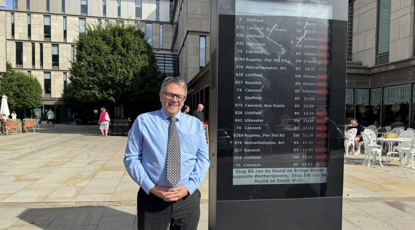 Andrew Mynors standing next to bus times totem