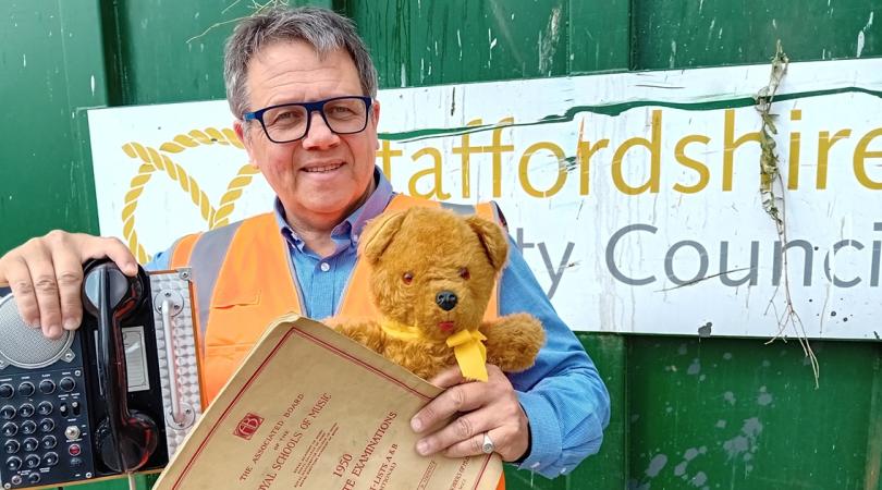Andrew Mynors holding items at household waste recycling centre