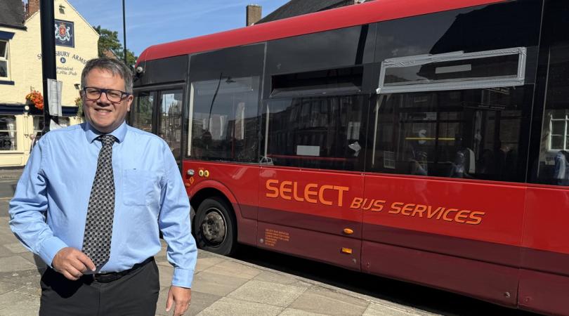 Andrew Mynors standing by bus
