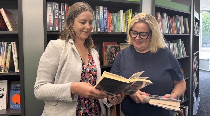 Hayley Coles inside library with Joss Scantlebury looking at books