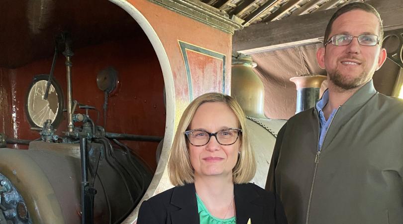 Jo Terry and Richard Lewis of the Archives service standing in front of the locomotive