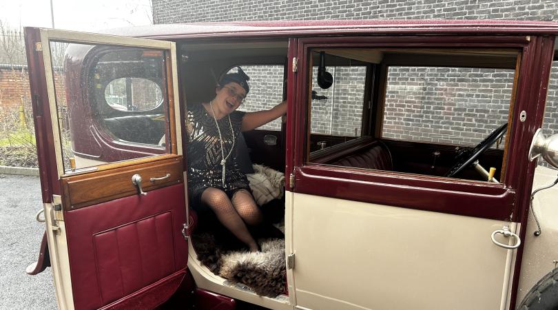 History centre's Lizzie Short posing in Rolls Royce wearing 1920s fashion