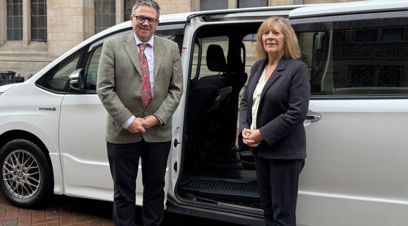 Andrew Mynors and Janet Higgins stood in front of taxi