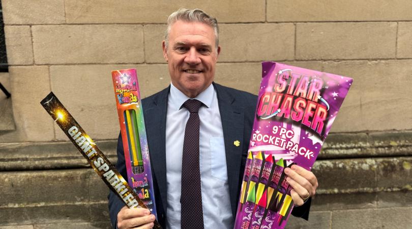 Cllr Anthony Screen holding fireworks in both hands