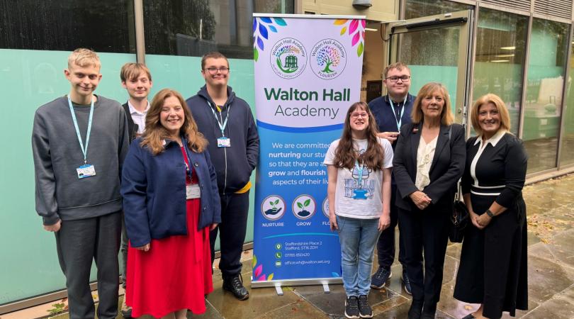 Janet Higgins, Cabinet Member for Education and SEND, and Julie Wood, Academy Principal, pictured with Walton Hall Academy pupils alongside a display banner.