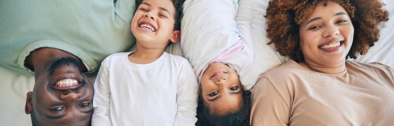 Picture of a family lying in bed
